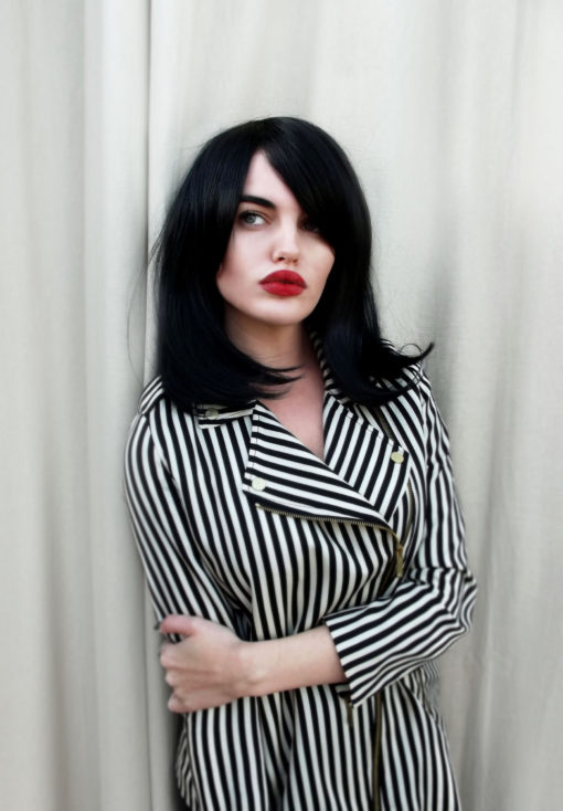 Paris - Lush Wigs UK Black long bob wig with bangs. Paris is simple and chic. Deep black colour in a sleek style, with a long fringe that can add extra layers around the face. Paint on that red lip and you're good to go.