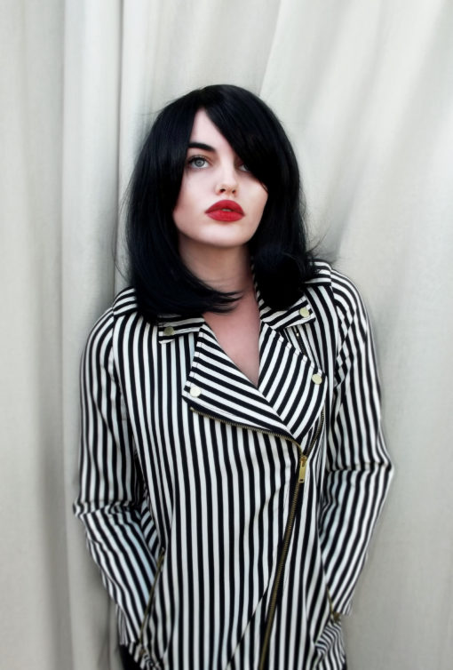 Black long bob wig with bangs. Paris is simple and chic. Deep black colour in a sleek style, with a long fringe that can add extra layers around the face. Paint on that red lip and you're good to go.
