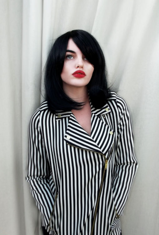 Paris - Lush Wigs UK Black long bob wig with bangs. Paris is simple and chic. Deep black colour in a sleek style, with a long fringe that can add extra layers around the face. Paint on that red lip and you're good to go.