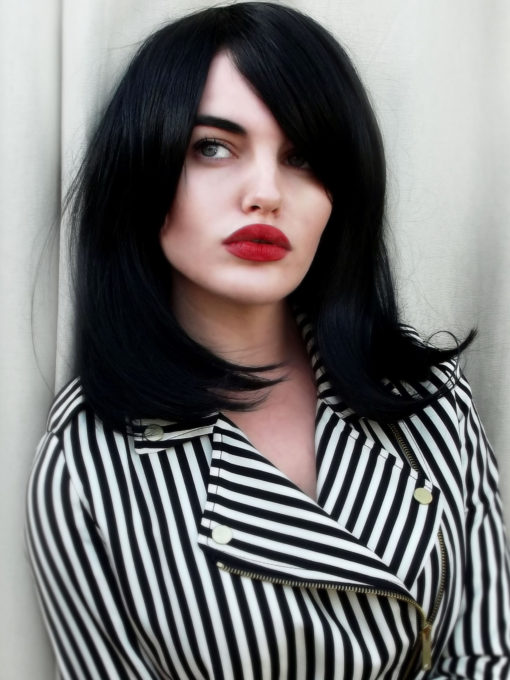 Paris - Lush Wigs UK Black long bob wig with bangs. Paris is simple and chic. Deep black colour in a sleek style, with a long fringe that can add extra layers around the face. Paint on that red lip and you're good to go.