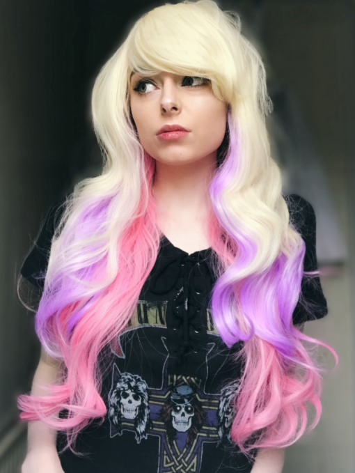 Blonde pastel long wavy wig with bangs. Sugar and spice and all things nice. Unicorn kisses locks pop with pretty pastels, of dreamy pinks and purples running through the barely there waves.