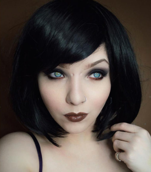 Betty is a classic 1920s Bob style with a twist. A jet black tone with purple blocks of colour, for a peek-a boo effect. A graduated cut that just falls past the jawline. Complete the look with dramatic makeup.
