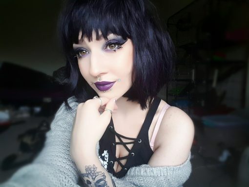 Betty is a Bob style with a twist. An inky black tone with purple blocks of colour, for a peek-a-boo effect. A graduated cut that just falls just past the jawline, with a full fringe.