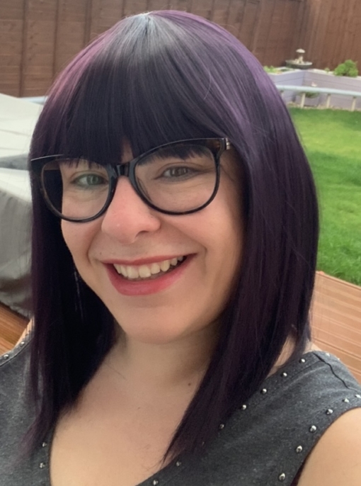 Betty is a Bob style with a twist. An inky black and with a subtle purple colour that catches the light perfectly. A sleek cut that just falls just past and curls under the jawline, with a full fringe.