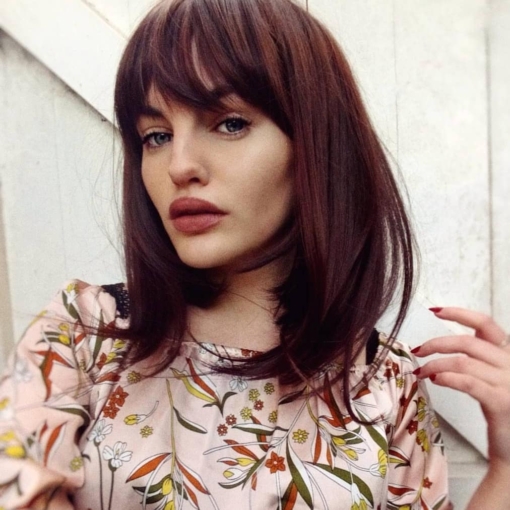 Chestnut is a rich brunette tone from the roots to tips. Sleek and blow dried with an inwards curl, skims the shoulders. With a fringe to frame the face.