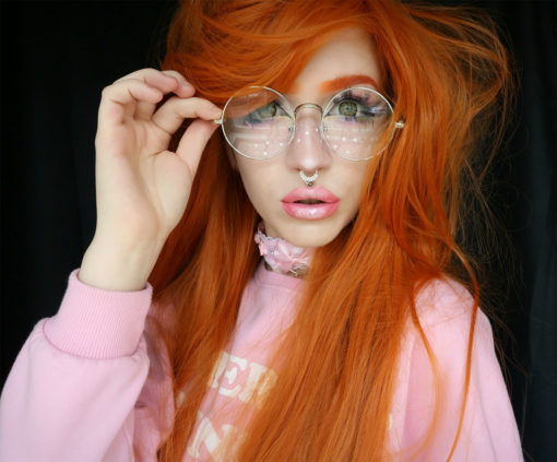 Orange long straight wig with bangs. This distinctive colour will get you noticed in Clementine dreams. A vivid orange colour from roots to tips. It's sleek with a subtle wave for texture.