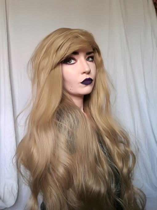 Blonde long wavy wig with bangs. Want a natural look with the wow factor?. Fawn is a light golden blonde colour. A loose wave runs through the style, with a long fringe.