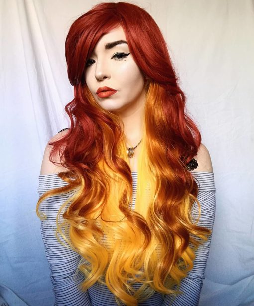 Thick and bouncy, Flame has a deep red outer colour, and layers of yellow and orange hair underneath which peep through the lengths. It is styled in loose curls and has a heavy, side-swept fringe.