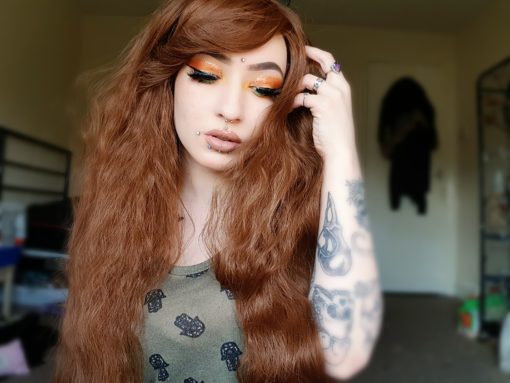 Forest Girl - Lush Wigs UK Medium brown long wig with soft waves. The waves are fairly tight, giving an almost crimped effect, but these can be brushed and softened. Natural style, with a side swept fringe. Perfect for a sweet, feminine or Mori look.