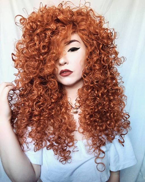 Big bright orange curly wig. Merida is in a league of its own! It is a tumbling mass of auburn set in tight ringlet curls. Naturally, as the name suggests, instant Princess Merida Brave vibes!
