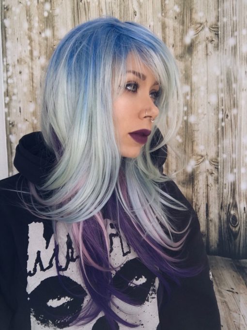 Multicolour straight wig with bangs. Prism creates a concoction of pastel multicolours. we love it! The top layer is dark blue at the crown fading to a pastel powder blue with a hint of mint, and the under-layers pop out as they are pink and purple.