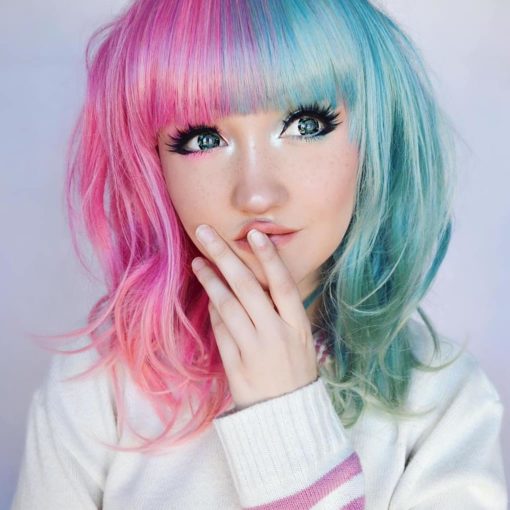 Pink and green split long bob wig. Candy split takes on the dramatic colour divide. These super cute pastel pink and green colours. Split down the centre parting and carry the colour through the fringe. Styled straight with plenty of volume and texture.