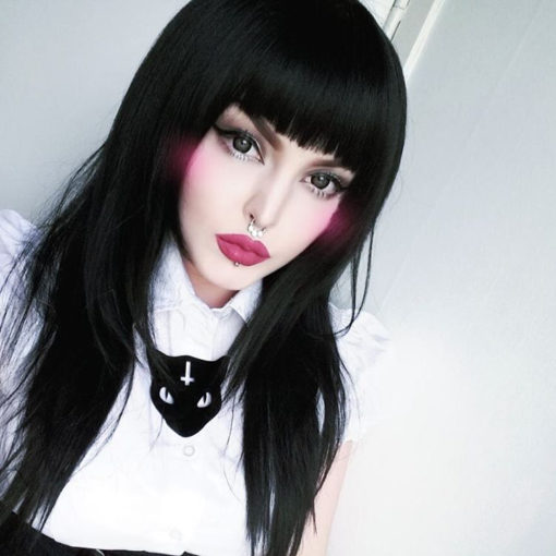 Salem is a layered but long black wig. The layers peak at shoulder length then continues to small layers below. It is sleek, shiny and straight, and the fringe a statement blunt cut.