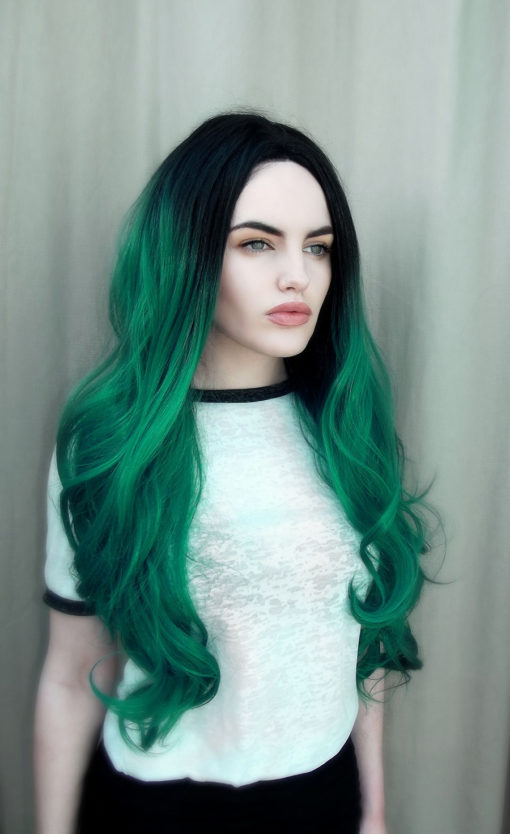 Green long wavy lace front wig. Forest Ombre certainly emulates earthy tones in this style. Dark black roots that run into a green ombre. Set with waves that end in cascading curls, that fall to the hips. Full of body and volume.