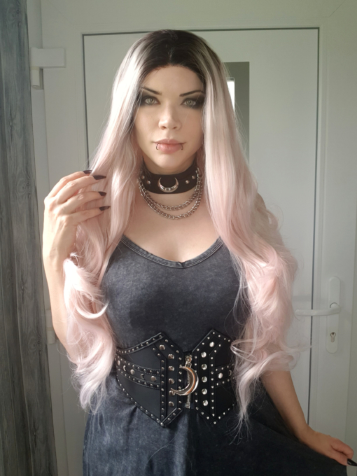 Powder pink long lace front wig with curls. Empress combines glamour with cute. A natural twist of black roots that fade into a pastel pink hue. Full of volume from the roots, styled in big bouncy curls.