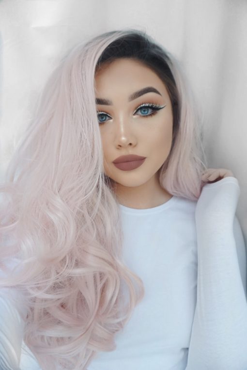 Empress combines glamour with cute. A natural twist of black roots that fade into a pastel pink hue. Full of volume from the roots, styled in big bouncy curls.
