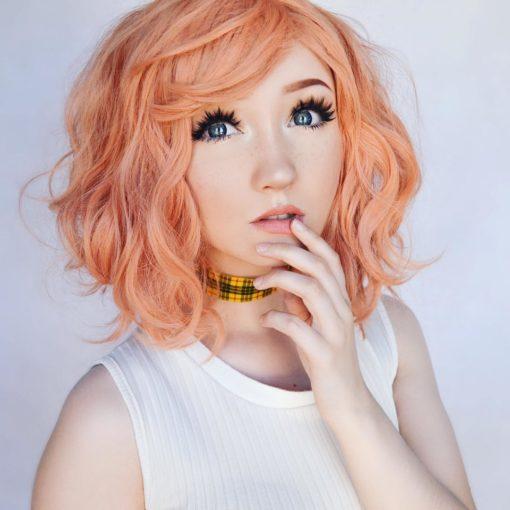 Peach wavy bob wig with bangs. Peach tea is a simple style that comes in a sweet peach shade. Styled in loose beachy waves for texture.
