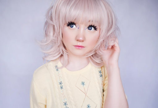 Pink bob wig with fringe. Add a little modern colour to a 1960s bob. Dusty Rose is a layered bob in a powder pink hue, with a 60s flick.