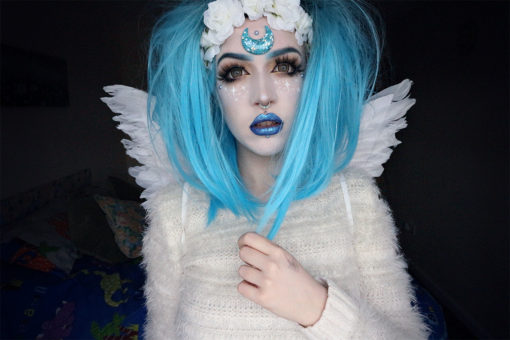 A sleek, blunt bob with black roots and a bright, electric blue dip-dye. Easy to wear, fringeless with a defined parting.