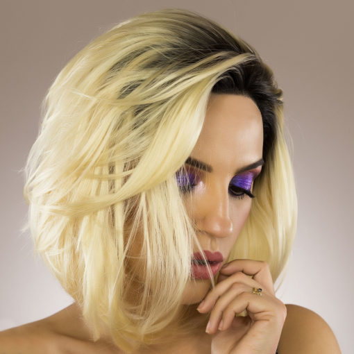 Honey blonde graduated bob lace front with black roots. The longer-at-the-front style gives this wig lots of movement, and the blunt cut makes it feel super thick. It has been styled with a blow-out effect for a more polished look.