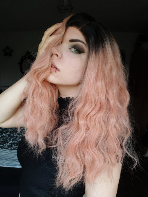 Peach long wavy lace front wig. Feminine and cool. Thunder comes with a natural twist of cool black roots that compliment the peachy rose gold undertones. Set in crimped waves creating lots of volume and bounce.