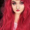 Pinky red long wavy wig with bangs. Want to make an impact? Then Red Sea with its unusual vibrant red, with whispers of pink tones produce this bold concoction of colour in barely there braided waves.