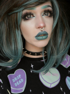 Debaser - Lush Wigs UK Blue and brown long bob wig. Grungy little bob with a brown base, and a washed out blue running through it. This cute style is slightly longer at the front giving it shape and movement. The full fringe can be trimmed blunt to suit the wearer, or worn long and swept over.