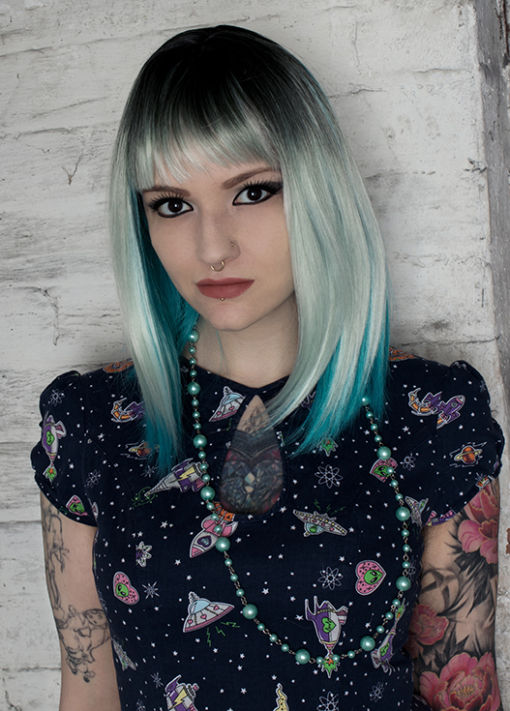 Skye is a beautiful mix of blues! Icy light blue for the top layer, cut in a shaggy long bob with blunt, wispy fringe. The layered style allows the rich teal blue bottom layer to peep through, creating a striking mix.