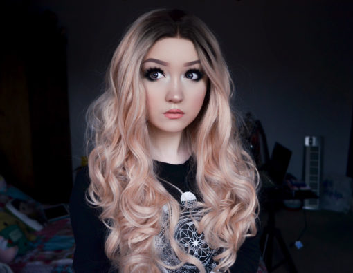 Camisole combines glamour with cute. Cool black roots fade into this pastel peach ombre. A lace front for a realistic hairline. Full of volume from the roots, styled in big bouncy curls that fall to the waist. Many ways to dress the locks into different styles.
