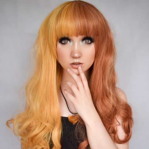 This dreamy split colour wig is super sweet! Light orange on one side, and a rich auburn colour on the other side, this style falls in loose curls at around bust-length. Finished with a heavy blunt fringe, that can be trimmed to suit the wearer.