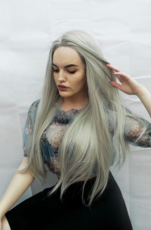 Light grey long straight lace front wig. Pale and interesting is Ghost. Light silver grey shades with smoky lowlights, with volume throughout.