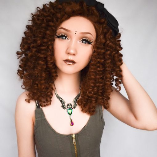 Golden brown spiral curls cut into a shoulder length style, Belle is a big and bold natural lace front. These tight curls fall in all directions, and with no defined parting they are free to be wild, or can be worn parted and tamed a little.