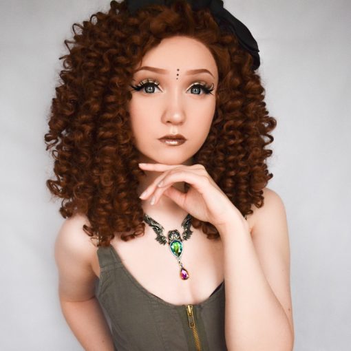 Golden brown spiral curls cut into a shoulder length style, Belle is a big and bold natural lace front. These tight curls fall in all directions, and with no defined parting they are free to be wild, or can be worn parted and tamed a little.