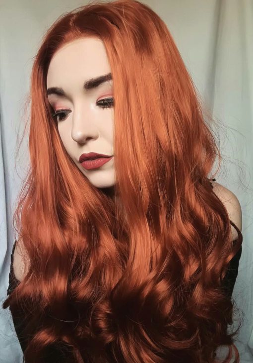 Orange red long curly lace front wig. Chilli is a bold concoction of colour with orange and red hues, with a pinch of ginger. Loose barrel waves bring this style to life.