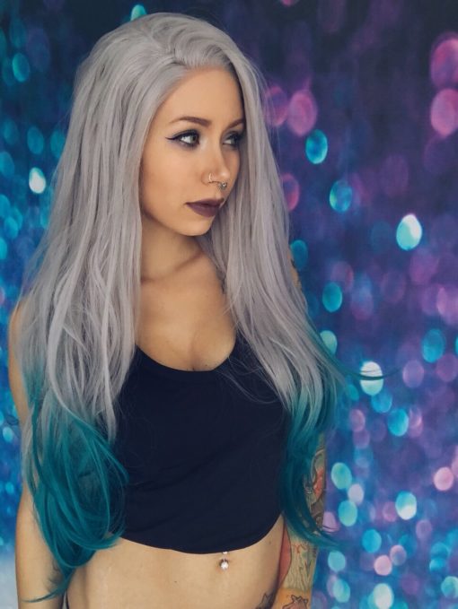 Deja blue is a lace front for a realistic hairline. An ash grey from the roots that blends into a teal blue ombre. sleek and long falling past the waist.