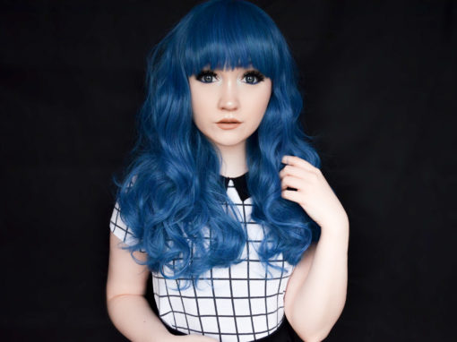 Bold blue curls and a blunt fringe, this is the ultimate bright wig. The many blue tones make this wig extra vibrant, and the thick, bust length curly style has plenty of movement. It has a full, blunt fringe.