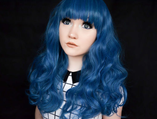 Bold blue curls and a blunt fringe, this is the ultimate bright wig. The many blue tones make this wig extra vibrant, and the thick, bust length curly style has plenty of movement. It has a full, blunt fringe.