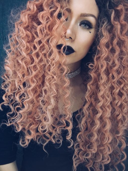 Peach big curly lace front wig. Spiral curls? check. pastel peach? check. = Persica, overflowing with big and bold spiral curls. Brown shadowed roots for a natural feel and Pastel peach locks.