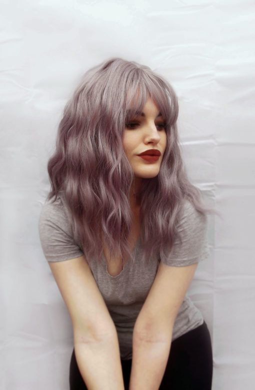 Beautiful, undone waves in a light dusky purple/mauve, Bliss is dreamy! This style falls just past the shoulder, and has a full fringe which can be trimmed blunt, or worn swept over. So pretty and an easy to maintain style, perfect for beginners and regular wearers.