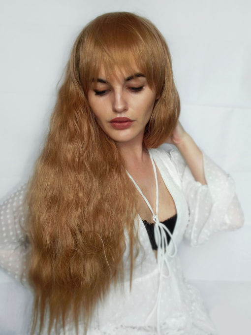 Full and fluffy, Paisley is a beautiful floaty natural style with plenty of movement. The tight waves create a very full effect, finished with a blunt fringe that can be trimmed to suit the wearer. The colour is a light strawberry blonde, perfect for pretty Spring/Summer looks.