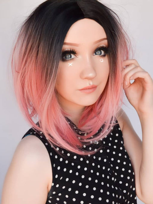 Rose pink straight bob with dark roots. XOXO takes pink hair to the next level with black shadowed roots that blend into a rose hue. As a classic chic bob, we can't get enough of it!
