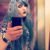 Blue grey long wavy wig with fringe. Are there fairies at the bottom of the garden? Grim Fairytale with its dark mix of grey highlights and indigo blue undertones, with crimped fluffy waves. Finished with dip-dye grey. 