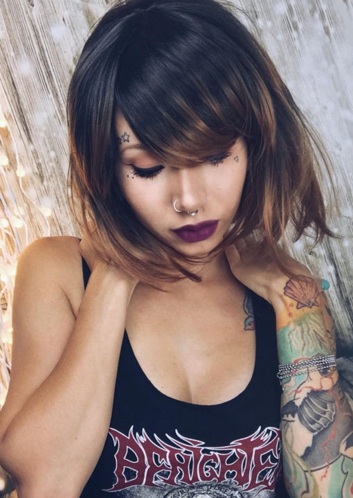 Black straight bob wig with bangs. Lucia is subtle, with just the right amount of edgy. Black roots and partially black lengths, that melt into a dark blonde/golden brown ombre.