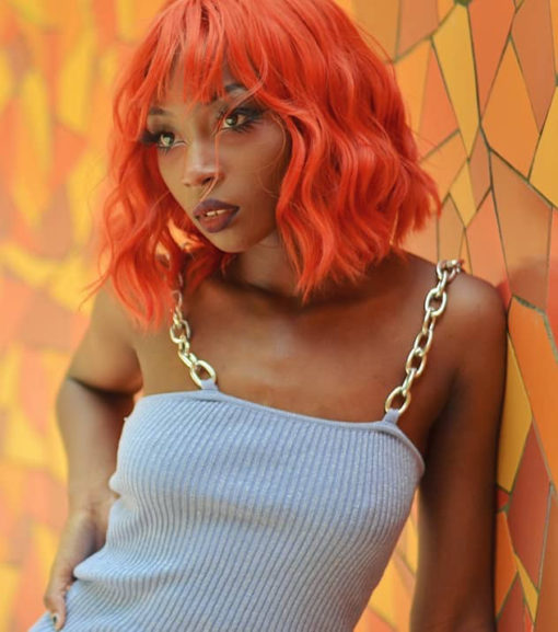 Tiger is one of our vibrant and rich styles that comes in a deep burnt orangey red shade. Loose beachy waves fall to the shoulders, with a light fringe to frame the face.