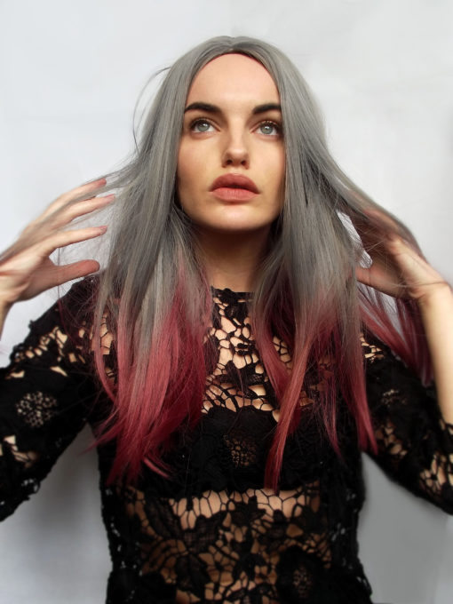 Glam, sleek style Carmine has cool grey lengths and a rich red dip-dye to finish off. Falling around bust length, this fringeless wig has a middle parting which keeps it easy to maintain. Simple with a twist!