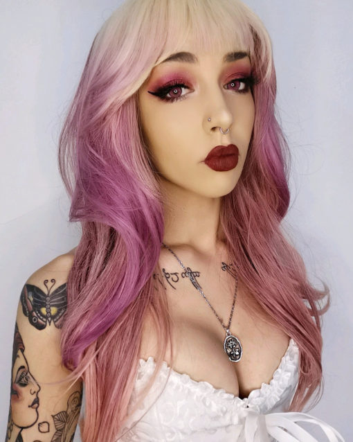 Blonde and pink long straight wig with bangs. Be the belle of the ball in dreamy Lullaby! With its bleach blonde overgrown roots. The angles of its very loose waves, reflects different tones of deep rose pink. A light airy blonde fringe with a touch of muted pink that skims the brow-bones.