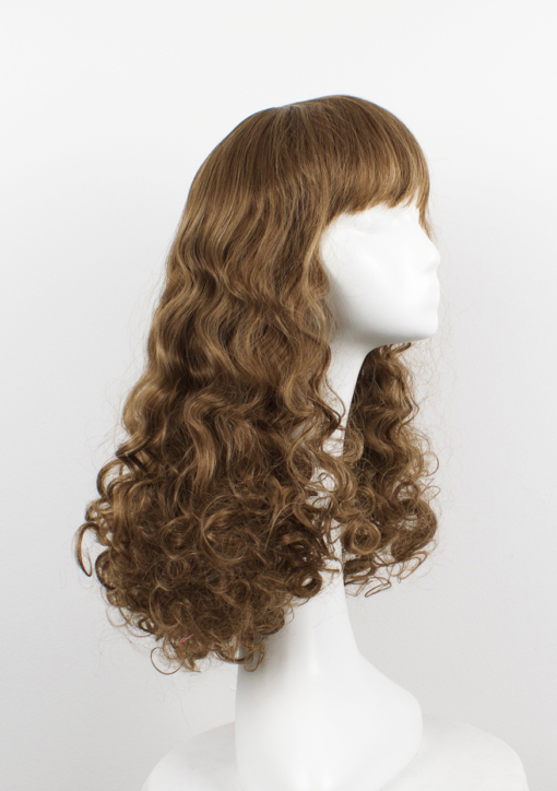 Inspired by the 1970s disco era Echo has tight curls, curtain bangs, in a light chestnut colour. It's studio 54 again!