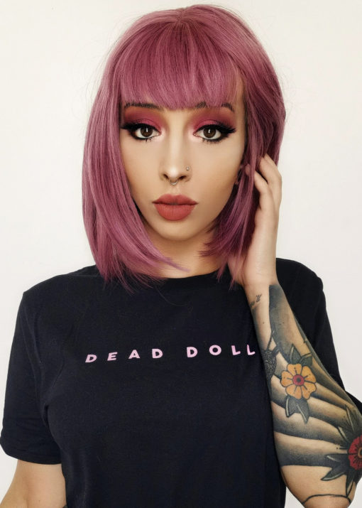 Pink purple straight bob wig with bangs. Primrose is a mixture of pretty deep rose pinks and subtle lilac tones, cut in an A-line bob.