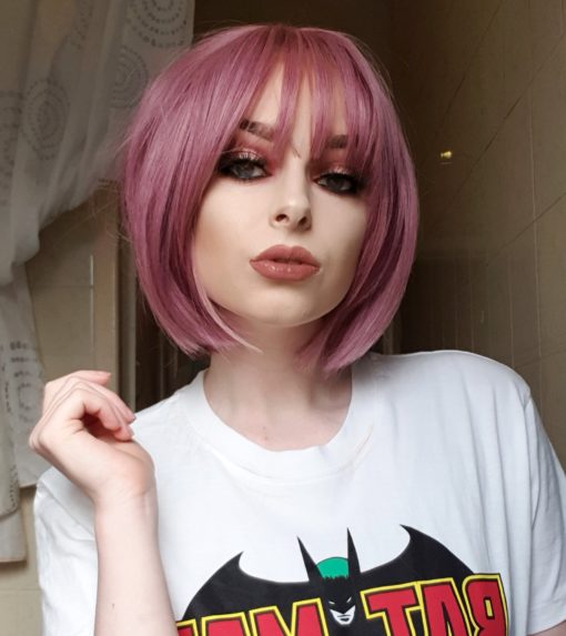 Pink purple straight bob wig with bangs. Primrose is a mixture of pretty deep rose pinks and subtle lilac tones, cut in an A-line bob.