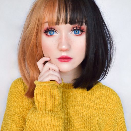Half orange half black split bob wig with bangs. Bumble takes on the split colouring technique that's soft and cute. Split down the middle of the centre parting. One half is a light amber and the other side is a cool black. With a light fringe.